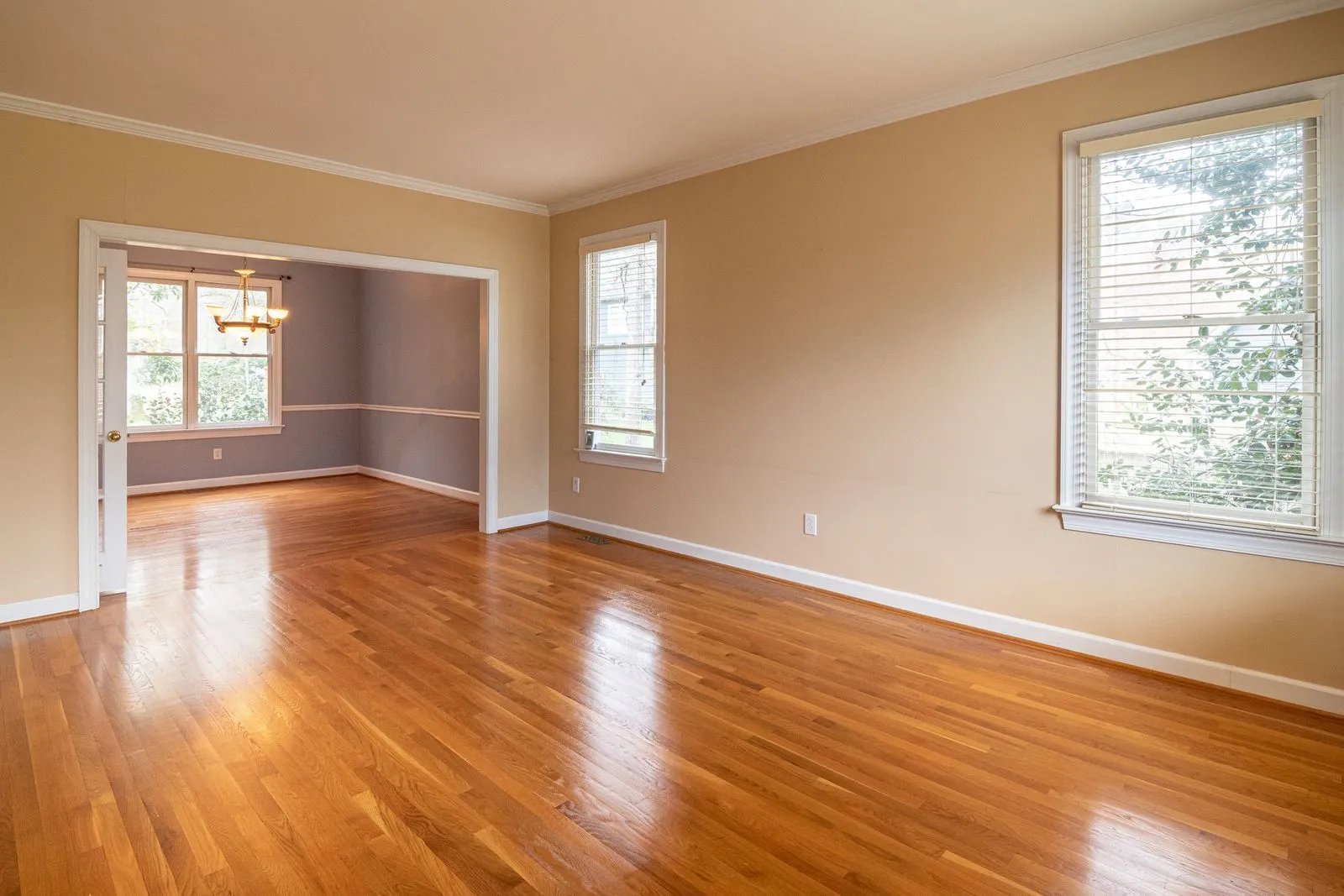 A sunlit room with gleaming oak hardwood floors