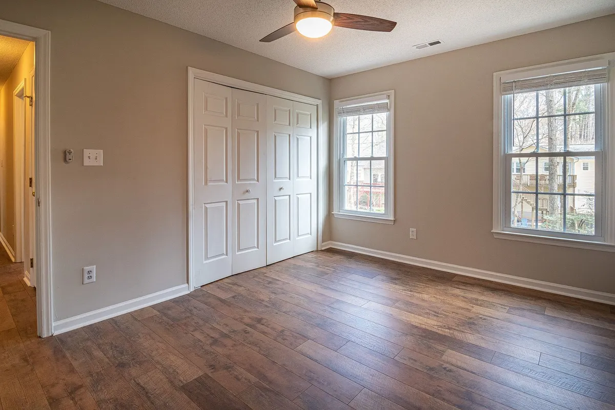 Rustic wide-plank flooring in a bright bedroom